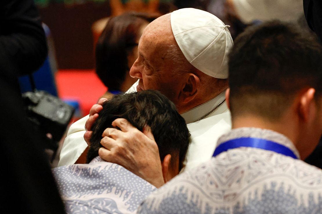 Pope Francis embraces a person on the day he attends a meeting with beneficiaries from charitable organizations, during his apostolic visit to Asia, at Indonesian Bishops